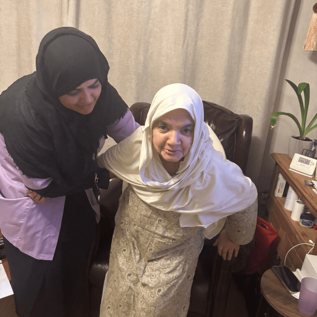 Thumhara assistant helping asian lady sit down