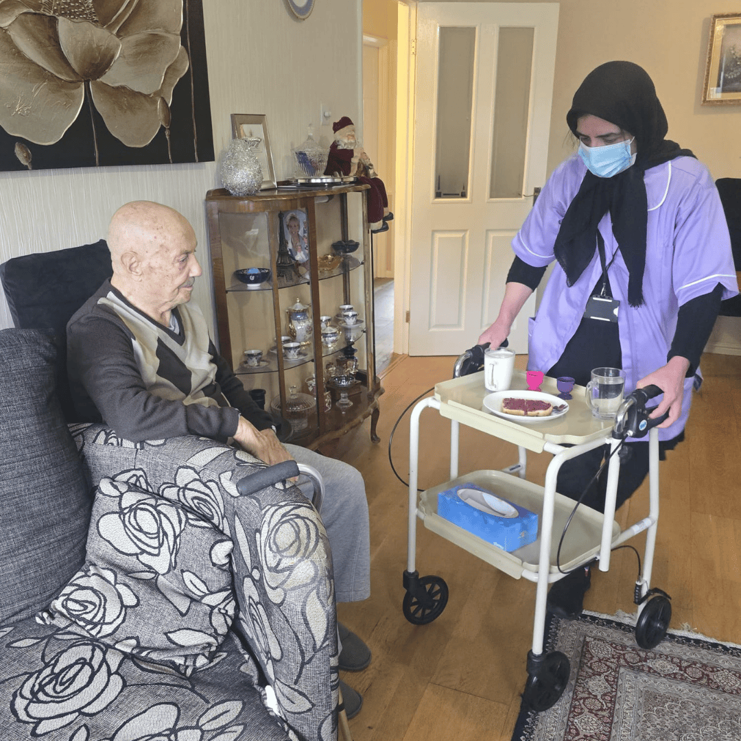 Thumhara volunteer bringing food trolley to elderly gentleman