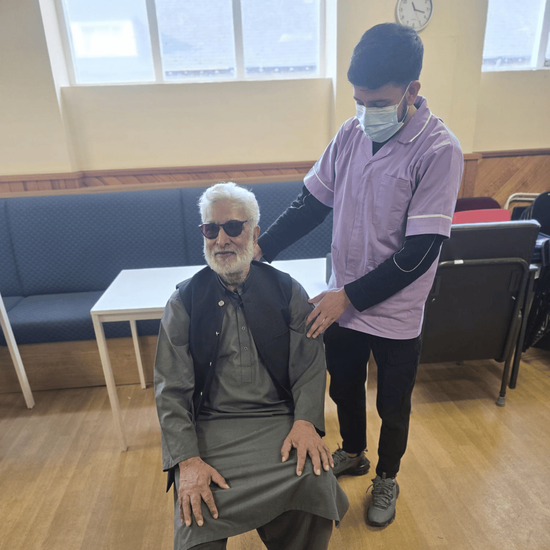 Thumhara helper providing support to elderly asian gentleman